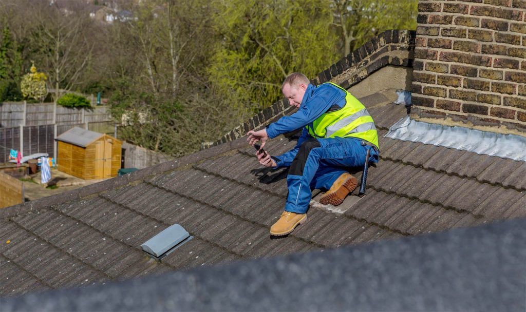 Man on the roof carrying out a roof inspection 